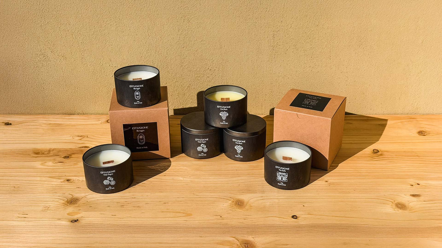 Collezione Echo di Effusione con candele profumate in cera di soia nelle fragranze Baraggia, Oasi Zegna, Uva Rara e Via Italia con packaging artigianale.